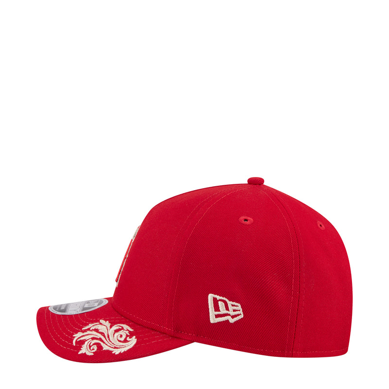 Red baseball cap with white New Era logo patch on side and decorated red brim.