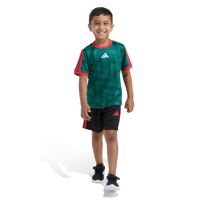 Kids green soccer jersey with red collar trim and black shorts with red adidas stripes.