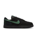 Black low-top Nike sneaker with green Swoosh and black rubber sole.