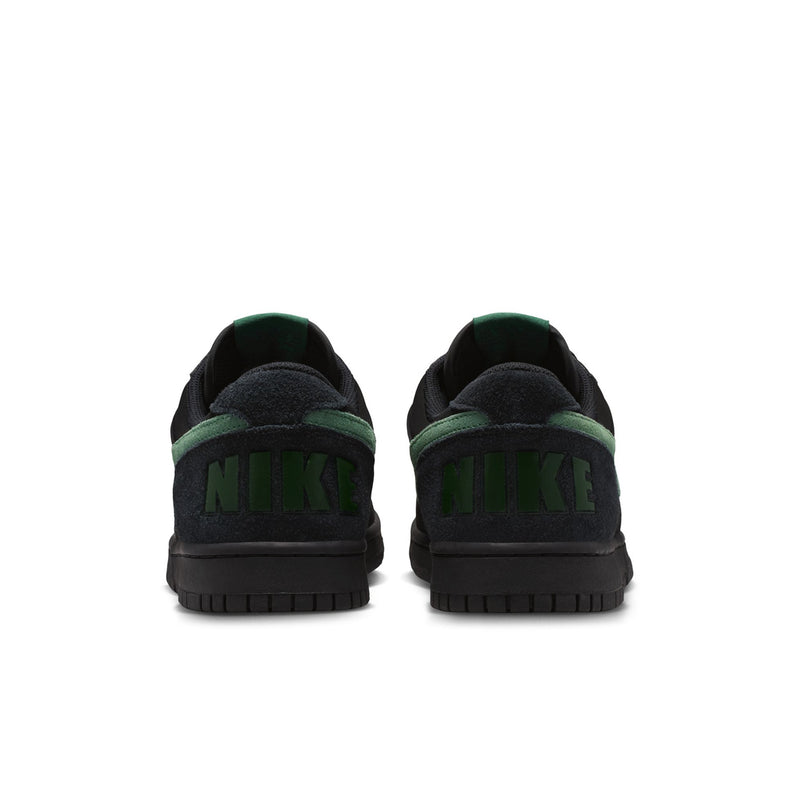 Black Nike sneakers with green heel pull tabs and cushioned collar.