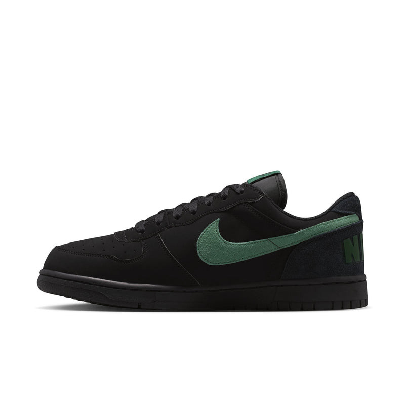 Black Nike low-top sneaker with green Swoosh and lace-up upper.