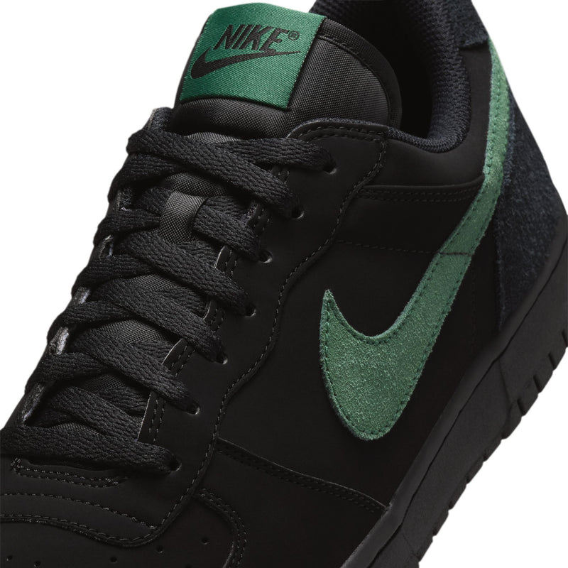 Black Nike sneaker upper with green Swoosh and textured laces.