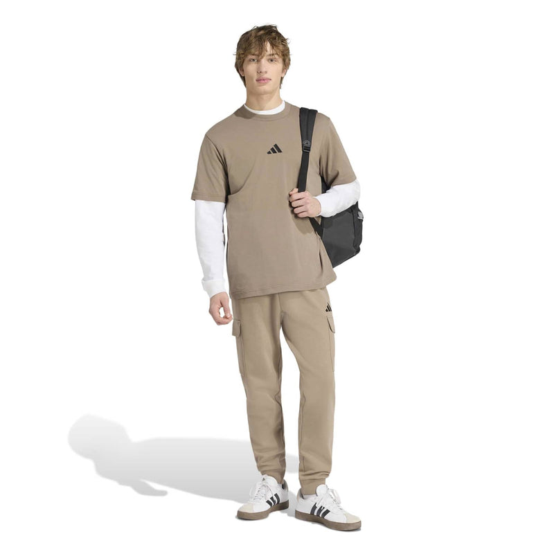 Khaki crew-neck T-shirt with black adidas logo; loose fit