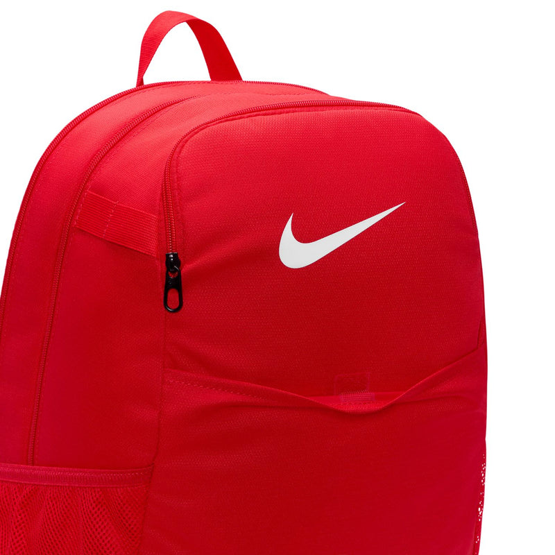 Red backpack front close-up with Nike swoosh and central zipper pocket detail.