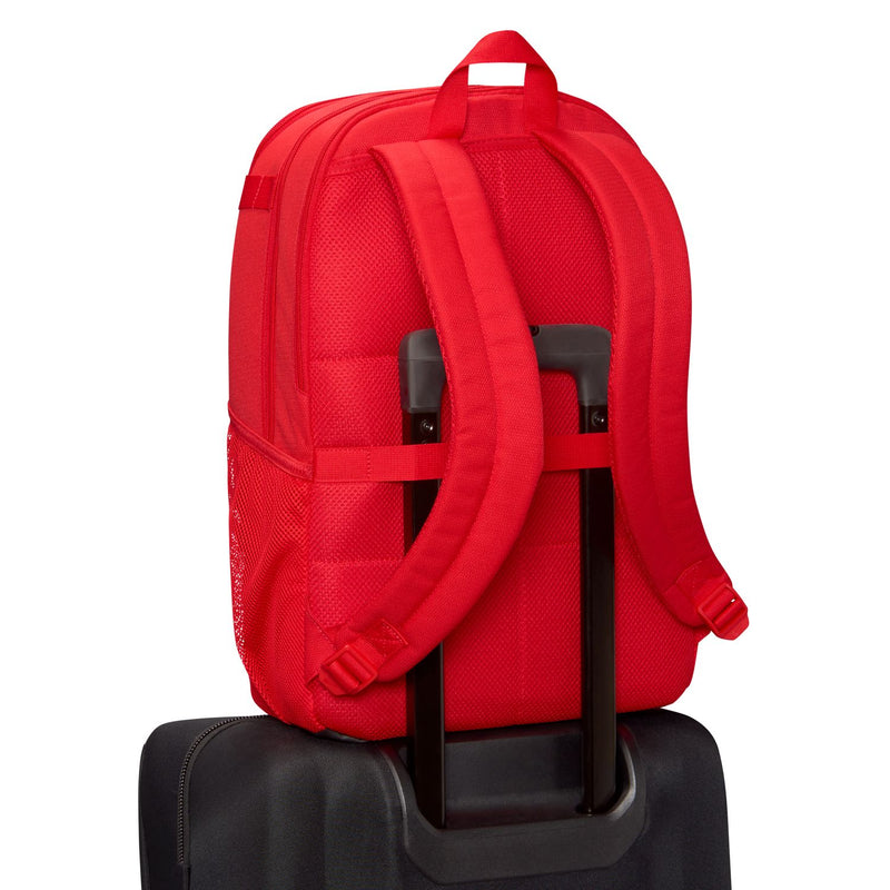Red backpack back view with padded straps and black top grab handle.