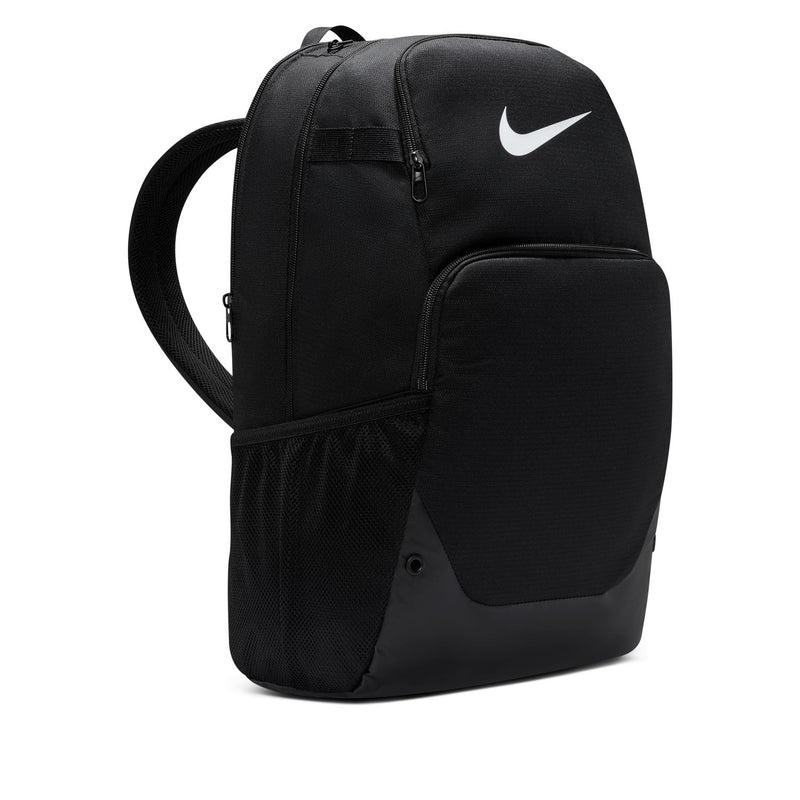 Nike Brasilia backpack side view, black body with white logo and adjustable shoulder straps.