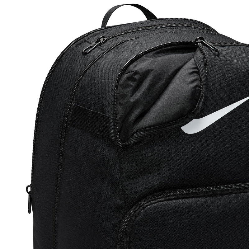 Nike Brasilia backpack close-up of top and front zippers with black interior lining.