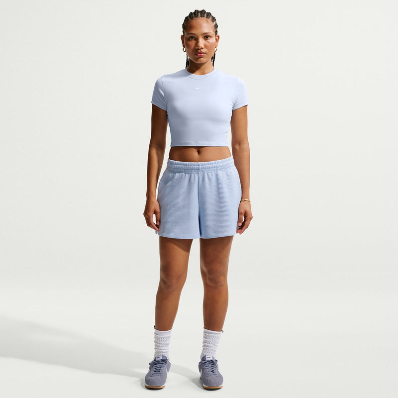 Light blue knit waffle shorts on a model, elastic waist and above-knee length