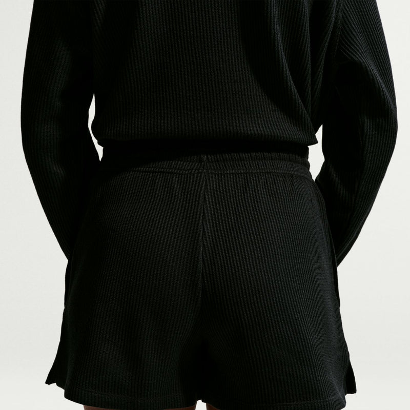 Black waffle-knit womens shorts close-up of elastic waistband and side seams