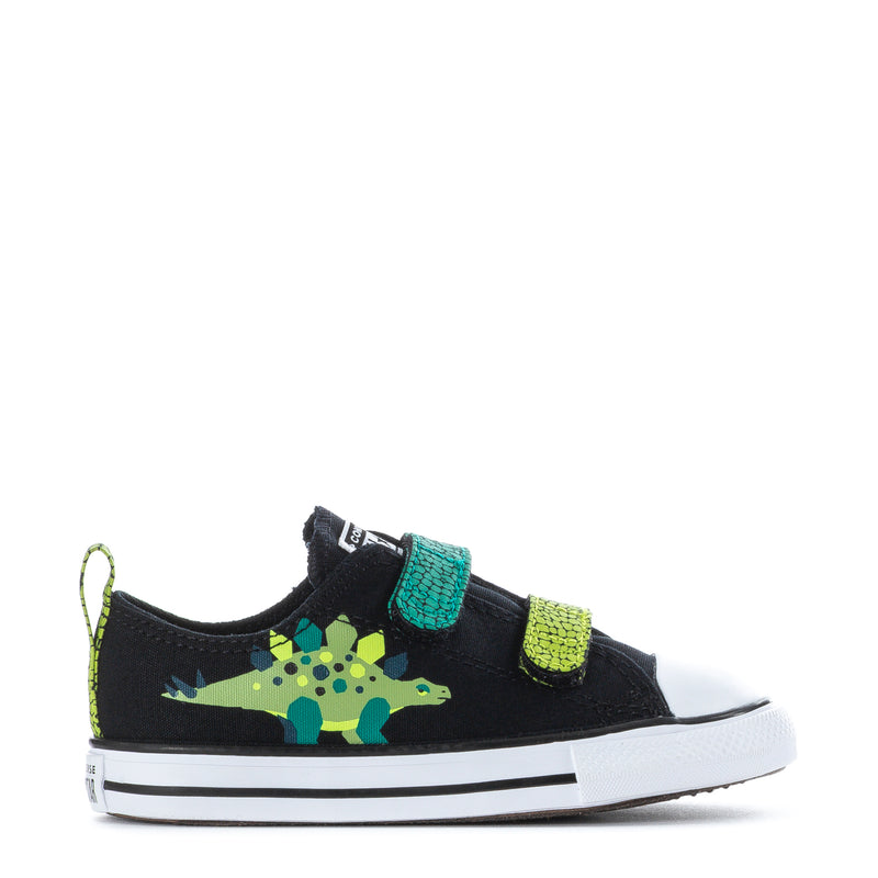 Toddler black dinosaur print sneakers with two neon green/teal Velcro straps and white sole