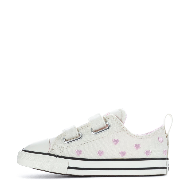 Toddler low-top canvas sneakers with white uppers, pink hearts, hook-and-loop closure