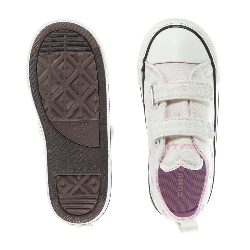 Toddler low-top sneaker view of sole and heel, white upper with pink heart lining