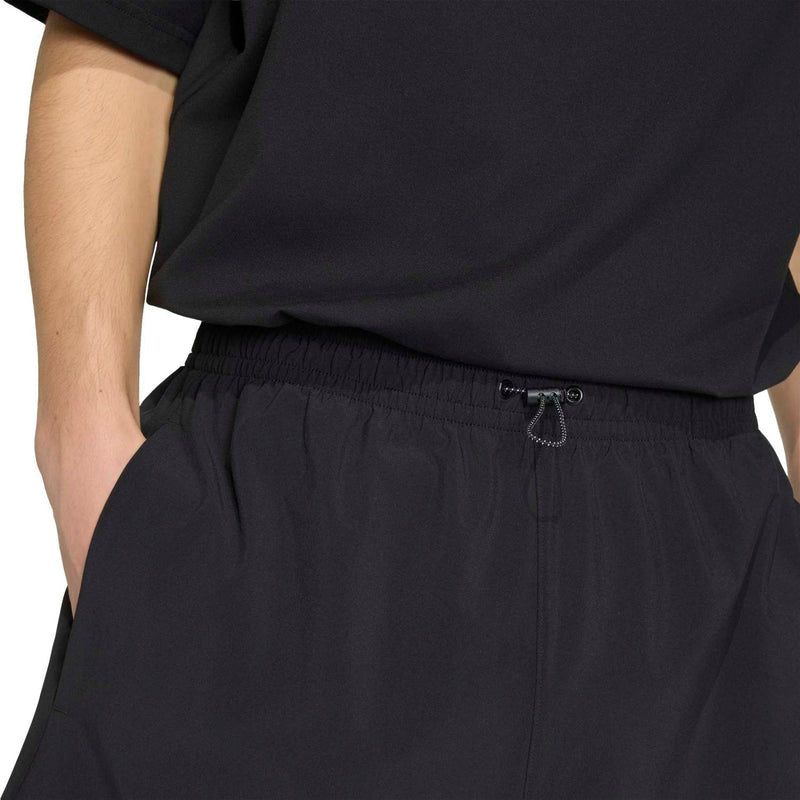 Black men's tech shorts with elastic waistband and inner drawstring cord.