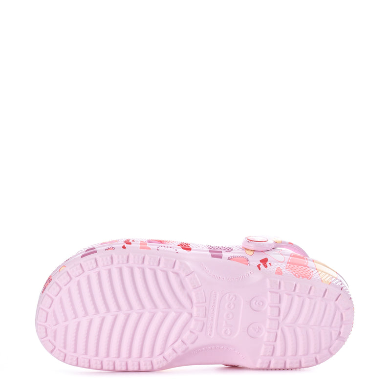Women's pink clog outsole with textured tread and heart-print upper