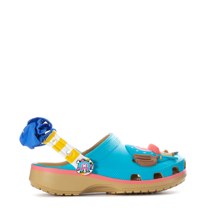 Youth classic clog in teal with pink trim, blue flower charm and cartoon Jibbitz