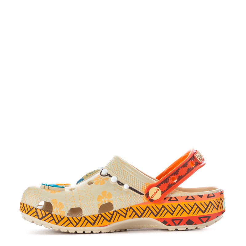 Youth clog with orange strap and decorative flower, patterned sidewall and rugged sole