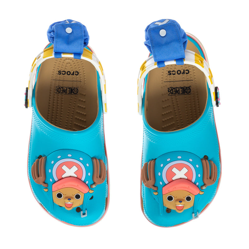 Teal youth clogs with blue heel straps and cartoon pirate graphic on the toe