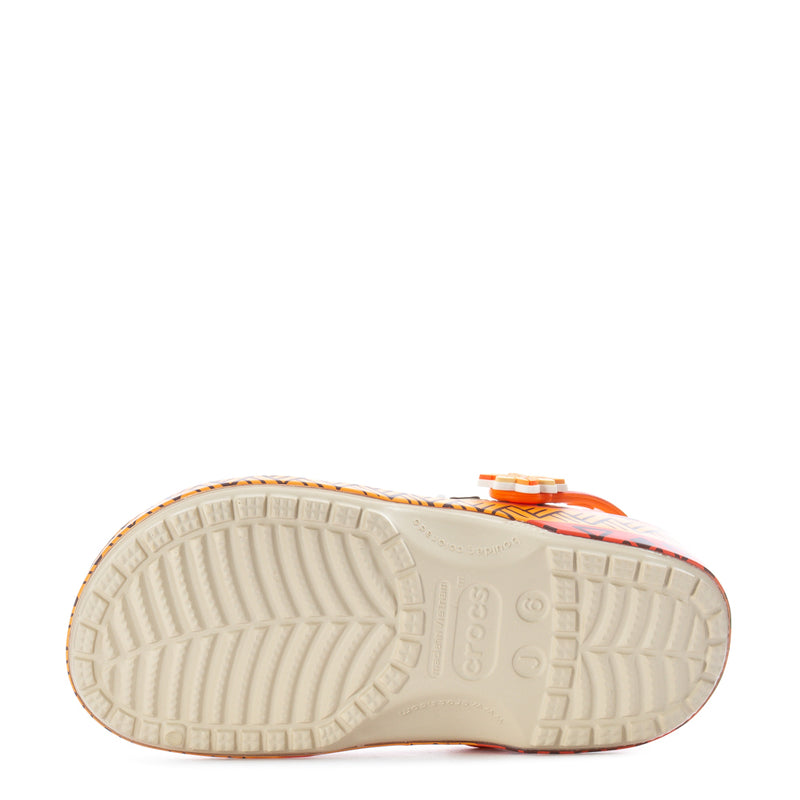 Youth clog outsole view with textured light sole and orange patterned edge