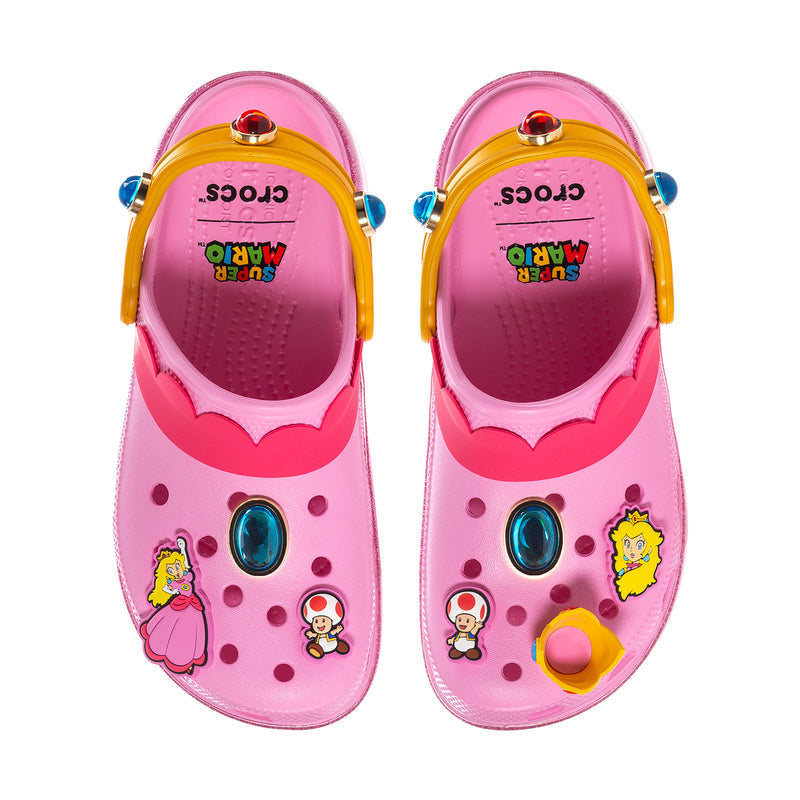 Womens pink clogs with openwork upper, cartoon patches, jeweled button detail