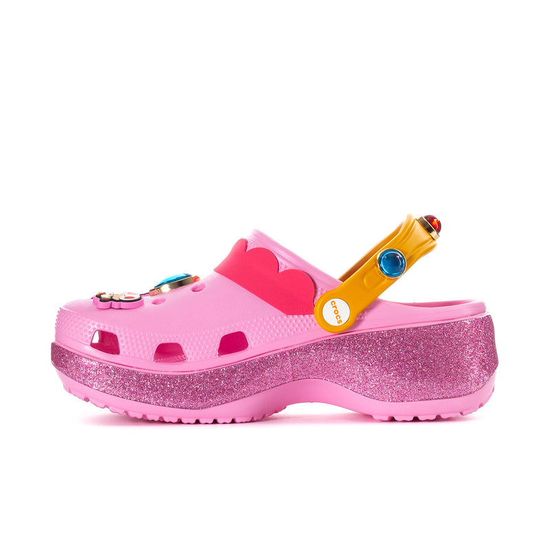 Womens pink platform clog with pink glitter sole, yellow strap, multicolor charm top