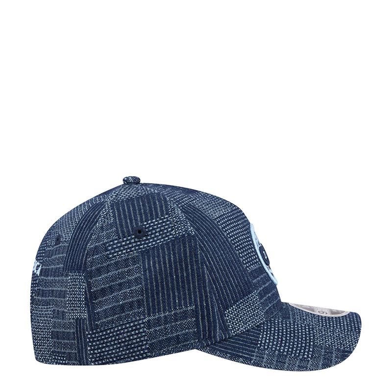 Denim A-frame baseball cap with blue patterned fabric, curved brim, and adjustable strap