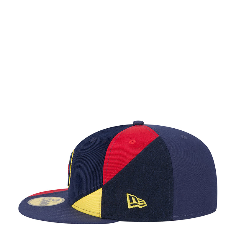 Navy snapback cap with red and yellow diagonal panels, New Era logo on front