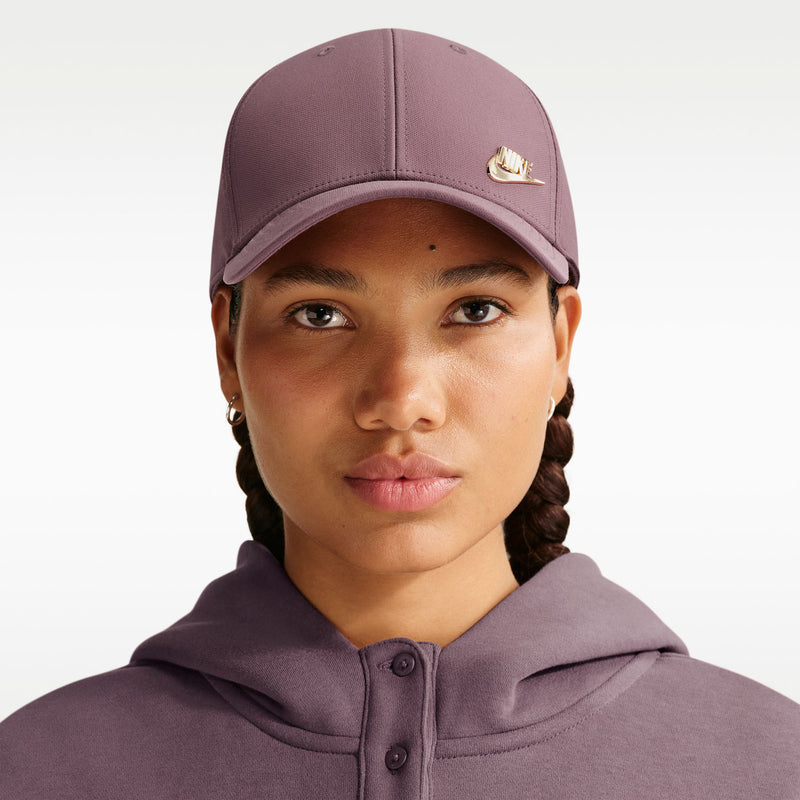 Nike club cap in mauve with gold logo on the front panel while worn