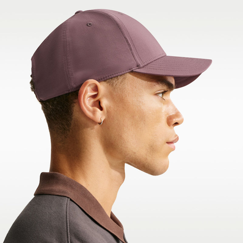 Nike club cap in mauve viewed from the side with curved brim and stitched panels