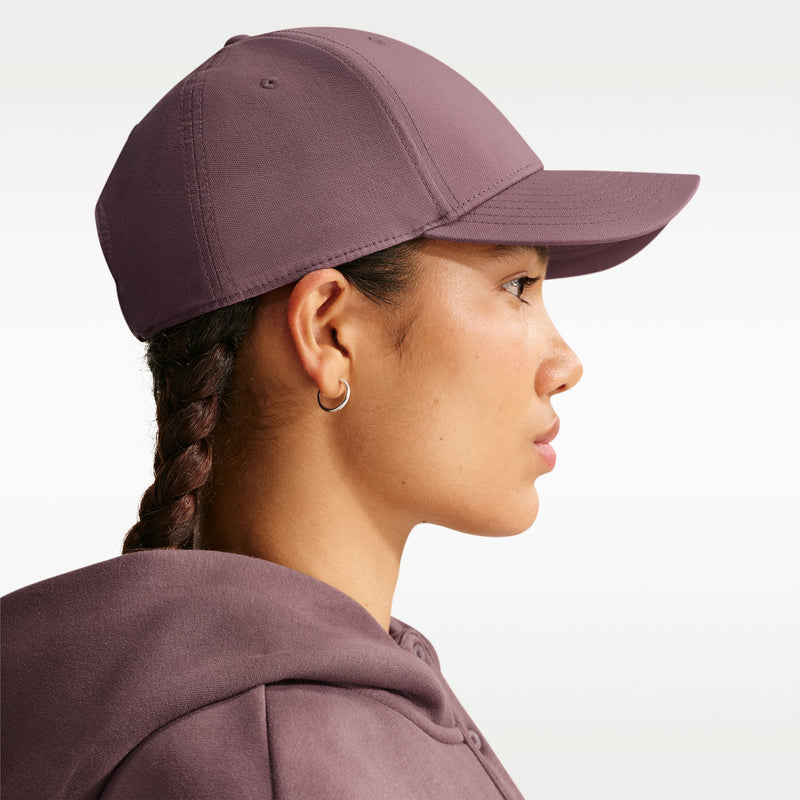 Nike club cap in mauve viewed from the back side with gold logo detail
