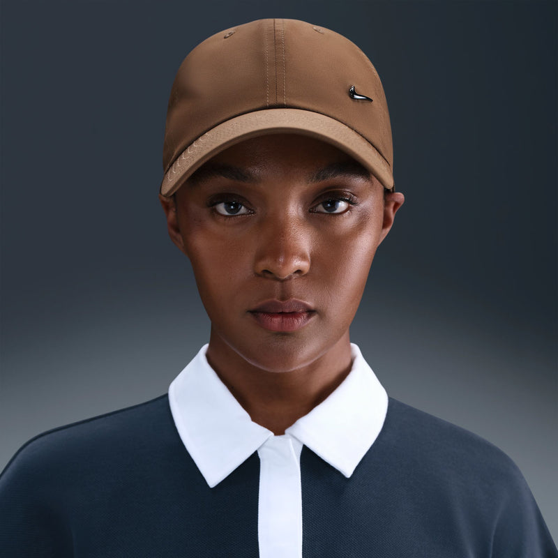 Mosswood brown Nike cap worn by model with curved brim and black Swoosh
