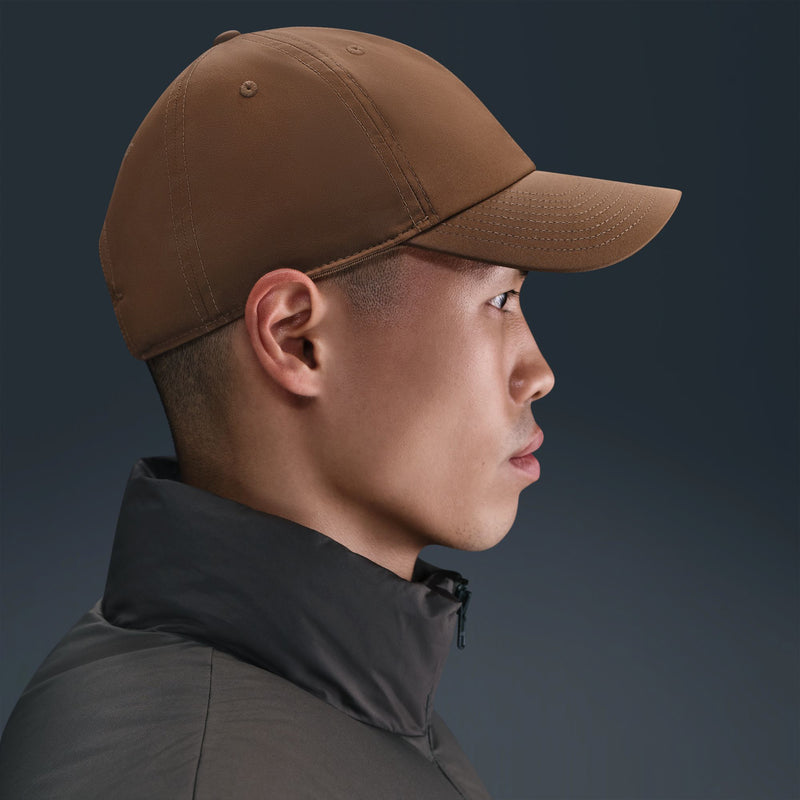 Mosswood brown Nike cap worn by model, side profile with black Swoosh