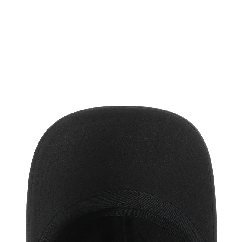 Black strapback cap close-up of crown and seam lines, curved brim edge.