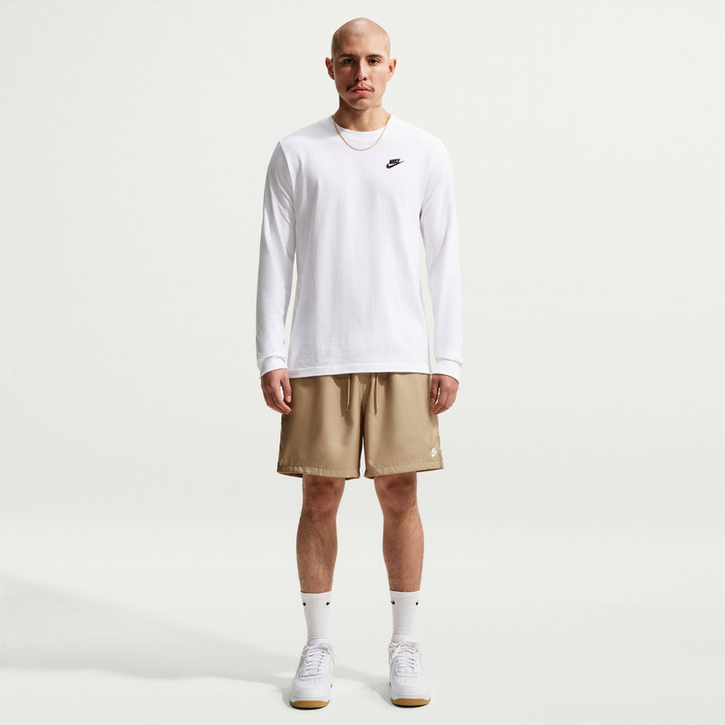 Men's parachute beige shorts worn with a white long-sleeve shirt