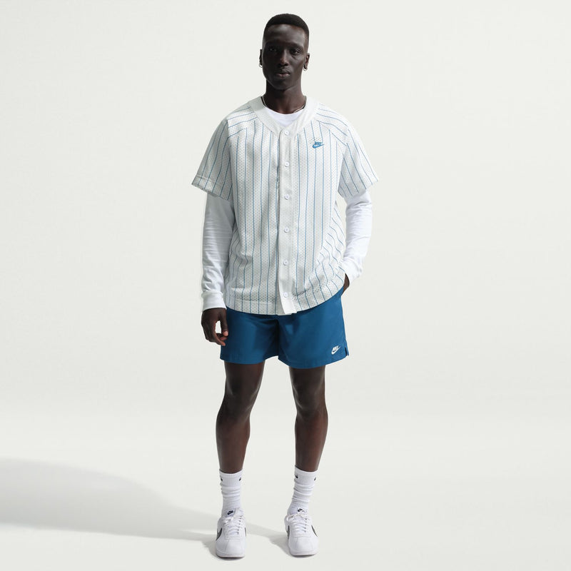 Men's blue drawstring shorts with elastic waistband, shown on-model with shoes