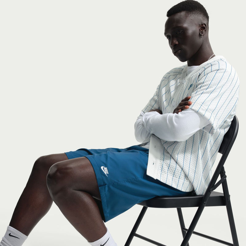 Men's blue drawstring shorts with elastic waistband, shown while seated