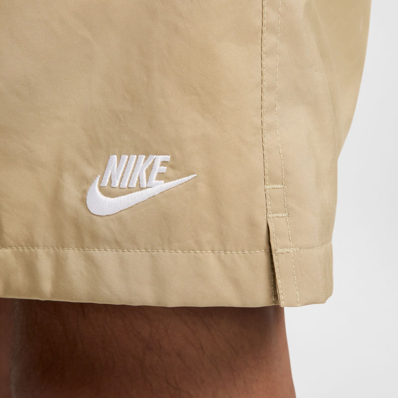 Parachute beige shorts with white Nike logo on the lower front