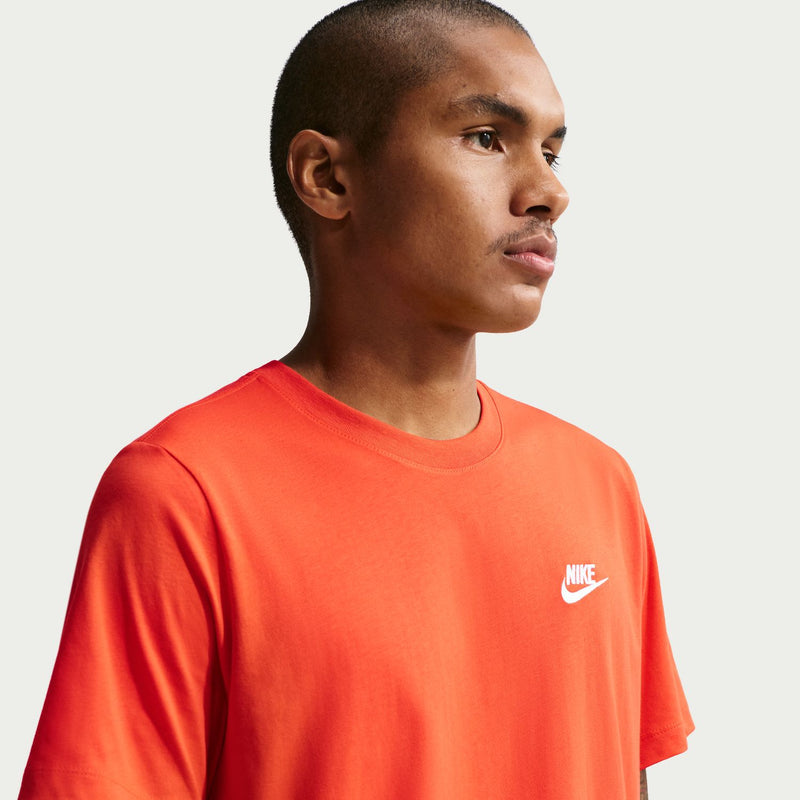 Men's coral orange crew-neck t-shirt, side profile with small Nike logo