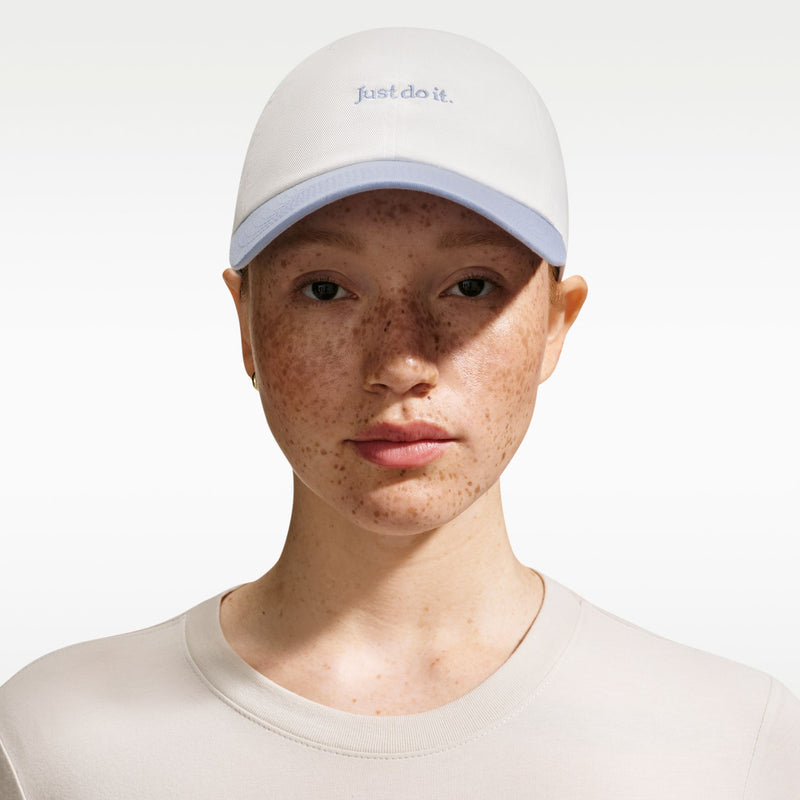 Cream cap with curved light-blue bill and small 'Just do it' text on crown