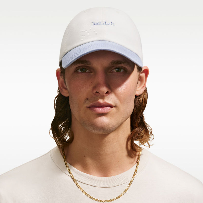 Cream unstructured cap with curved light-blue bill and 'Just do it' logo on crown
