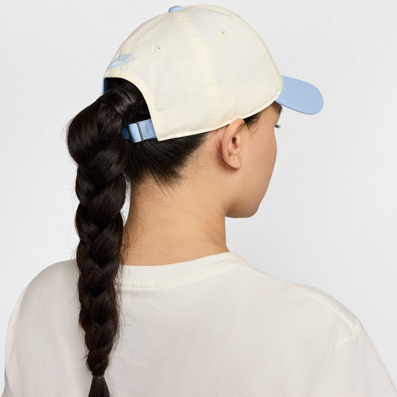 Cream unstructured cap with curved light-blue bill, rear view