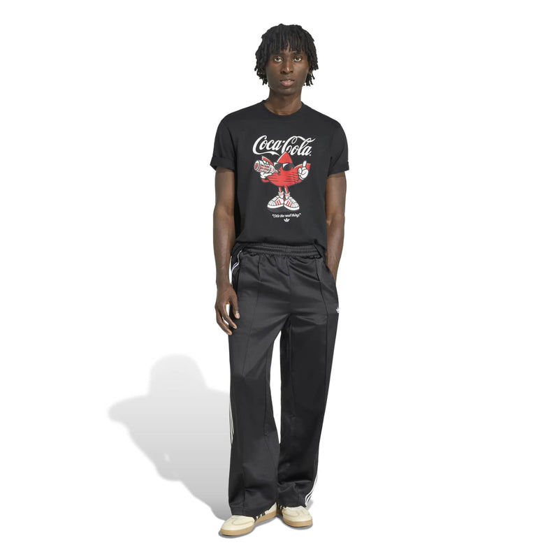 Men's black T-shirt with Coca-Cola logo graphic, worn with black pants