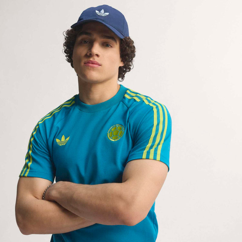 Teal men's soccer T-shirt with yellow side stripes, crest and Adidas logo on chest