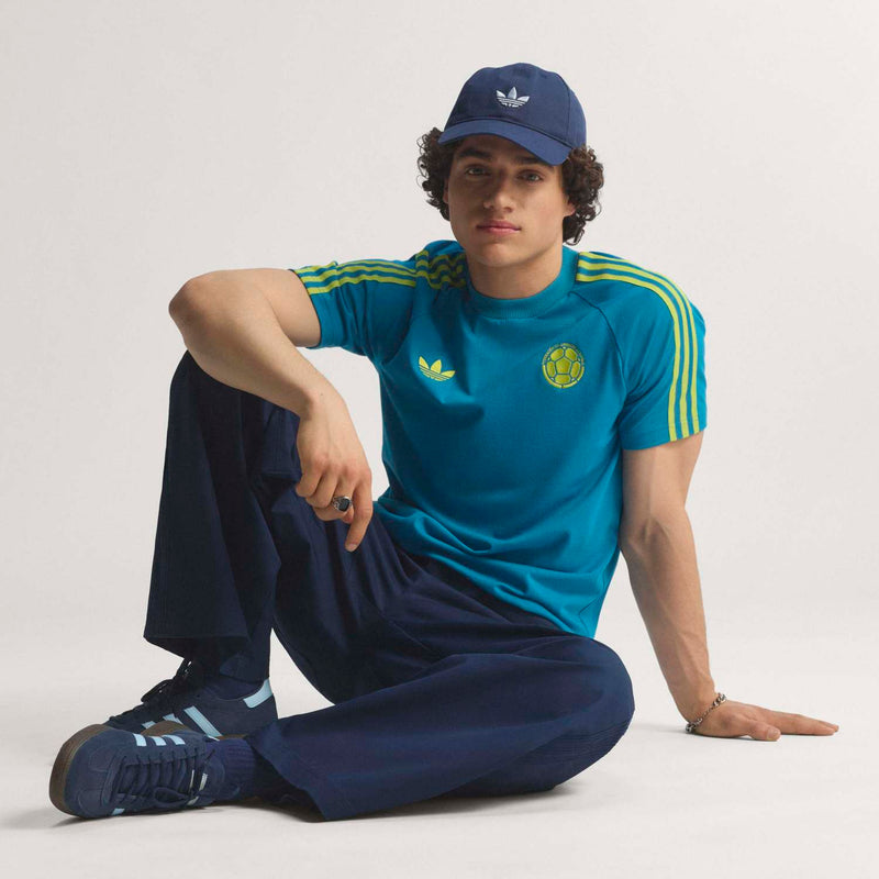 Teal men's soccer T-shirt with yellow Adidas logo, crest, and ribbed crew neck