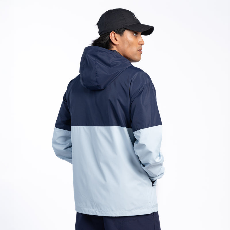 Navy and light-blue hooded windbreaker jacket, side view with full zip front.