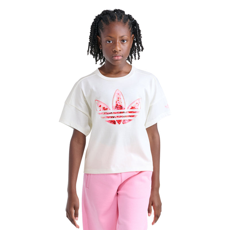 Youth off-white confetti trefoil graphic tee on model, front view with pink pants
