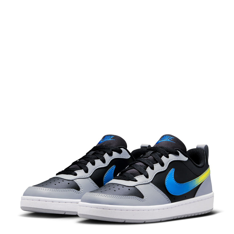 Pair of youth low-top sneakers in black, white, blue, and neon yellow