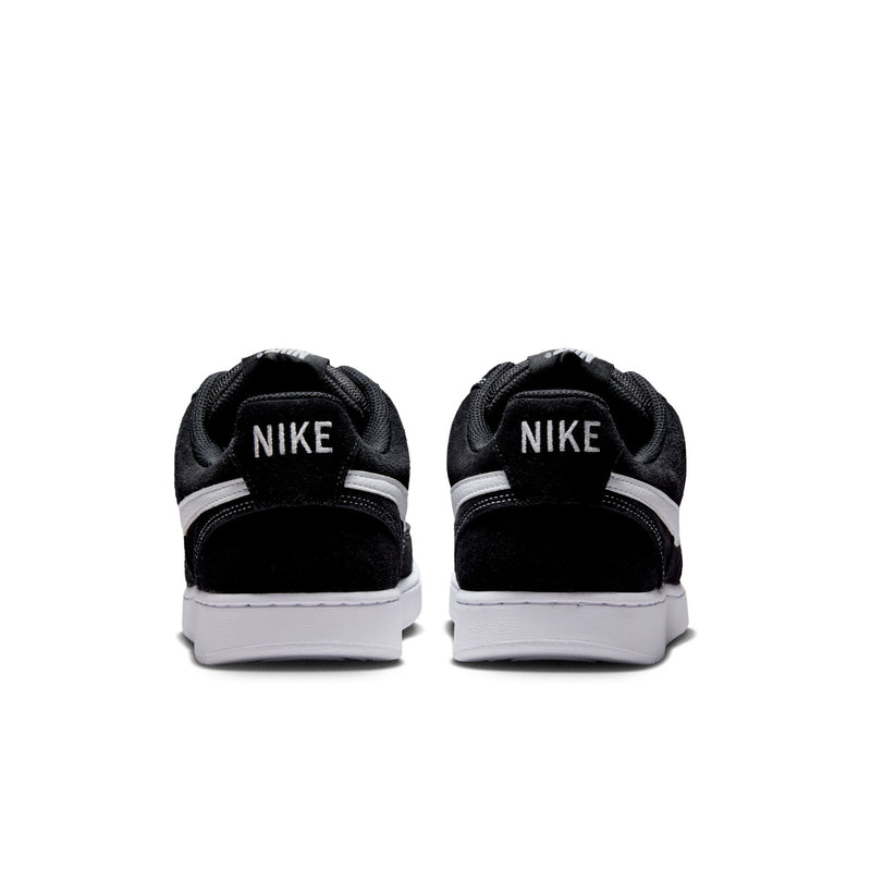Black low-top sneakers with rear NIKE branding and white midsole