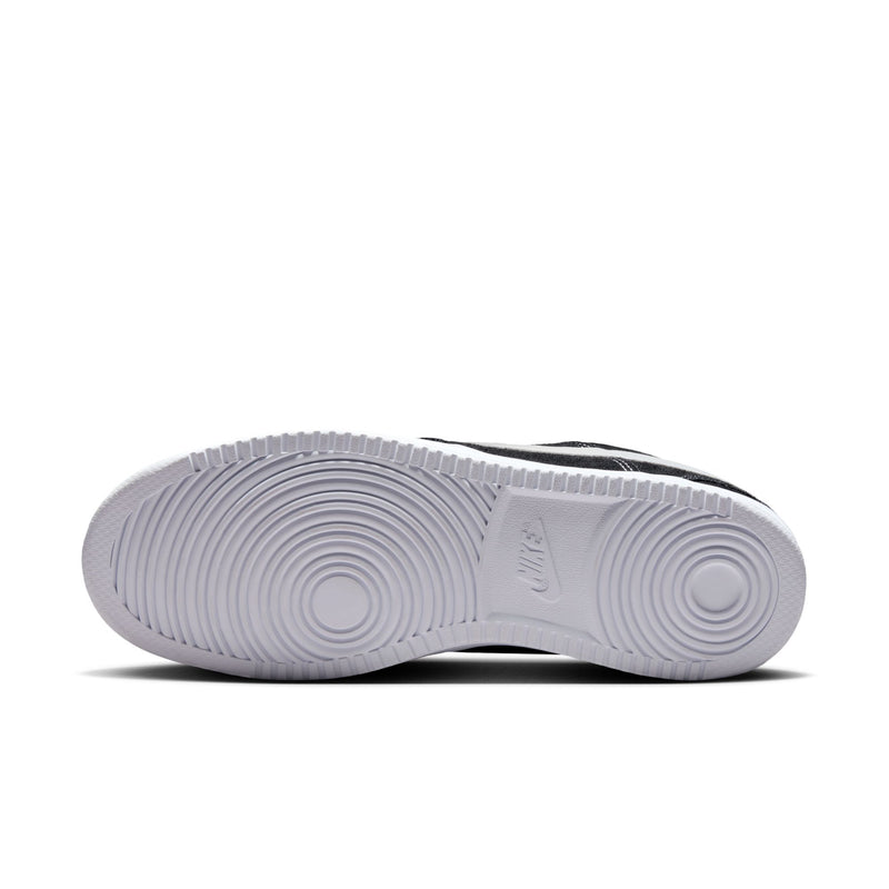 White rubber outsole for black low-top sneakers with circular tread pattern