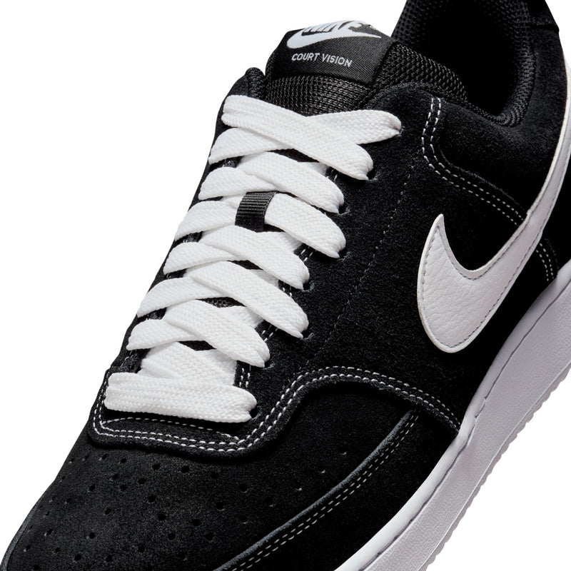 Black suede low-top sneaker with white laces, stitched seams, and COURT VISION patch