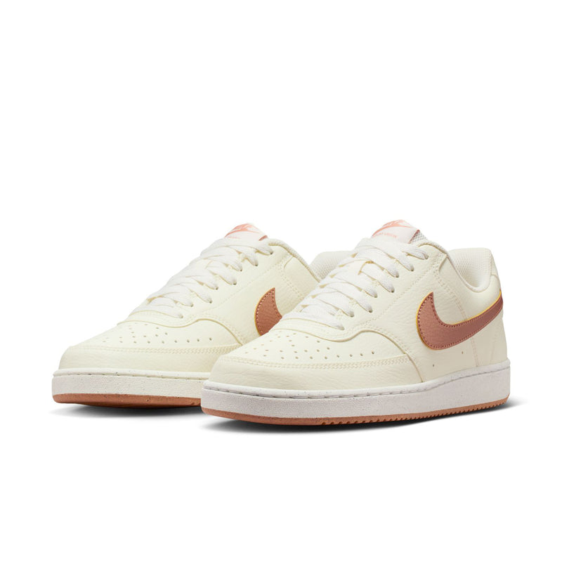 Pair of women's sail low-top sneakers with rose-gold pink Swoosh and tan rubber sole